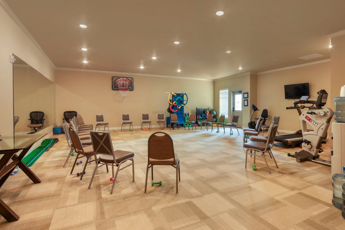 An empty room with chairs arranged in a circle, suitable for a meeting or group discussion.