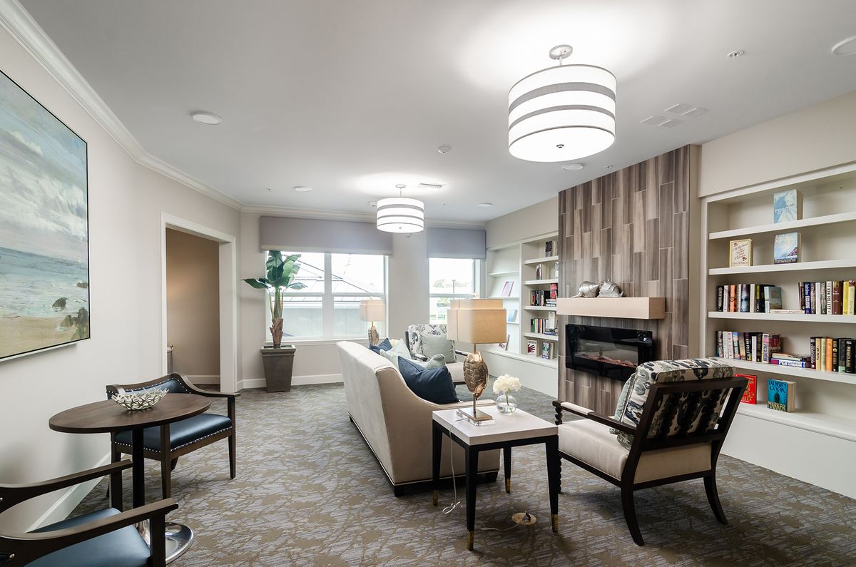 A modern and cozy living room featuring stylish lighting, a fireplace, and comfortable seating.