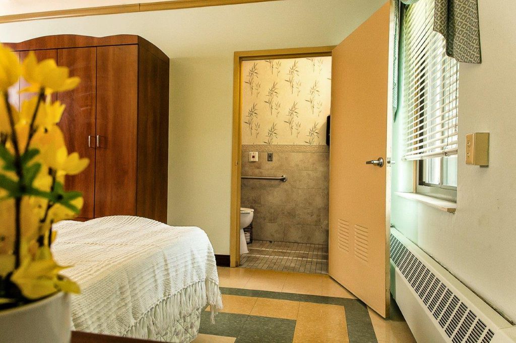 A cozy bedroom with a view into the connected bathroom.