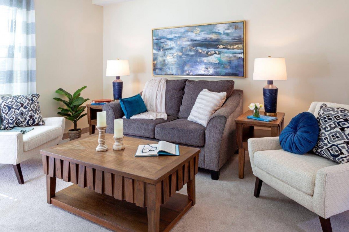A cozy living room with a comfortable sofa, wooden coffee table, and decorative accents.