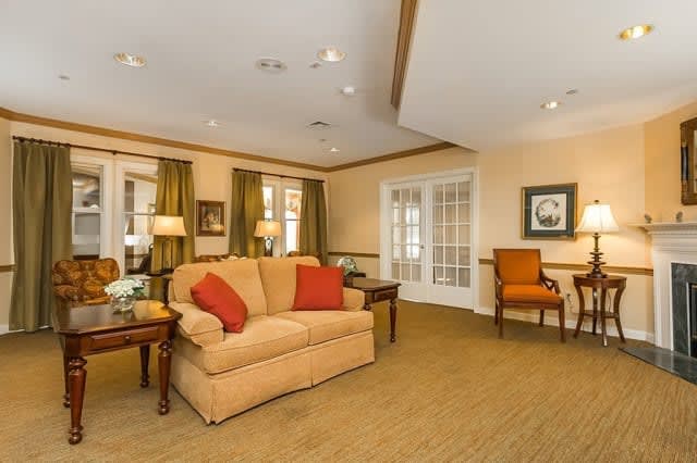 A cozy living room with a beige sofa, warm lighting, and decorative elements.