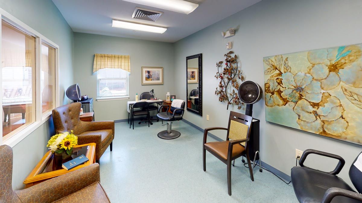 A cozy hair salon interior with chairs, a mirror, and a hair dryer.