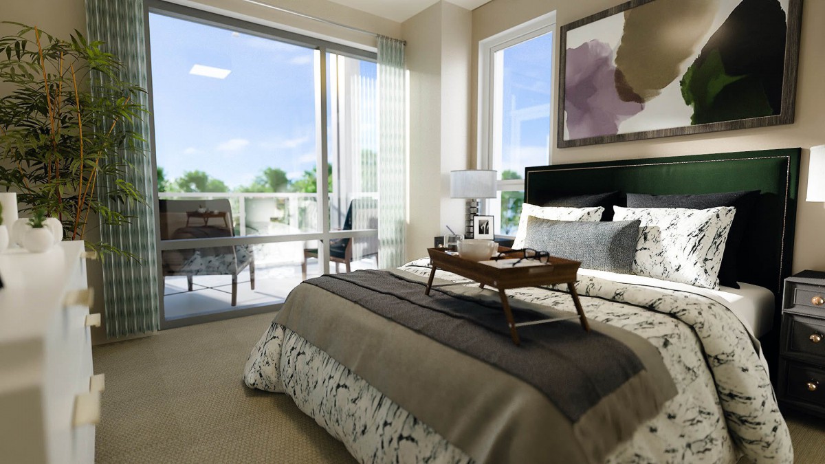 A modern bedroom featuring a neatly arranged bed with a breakfast tray, large windows allowing natural light, and access to a balcony.