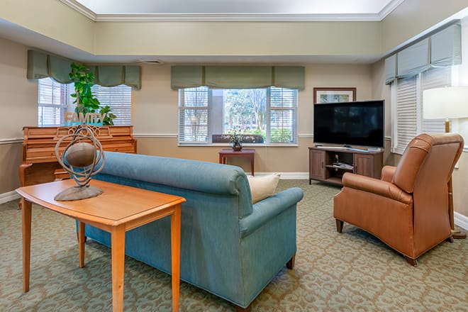 A cozy living room with comfortable seating and a large television.