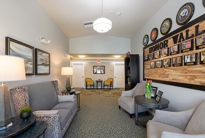 A cozy lobby area with comfortable seating and wall decor.