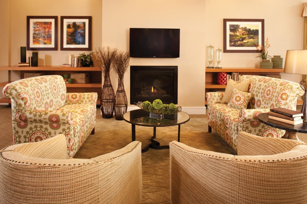 A cozy living room with stylish furniture and a warm fireplace.