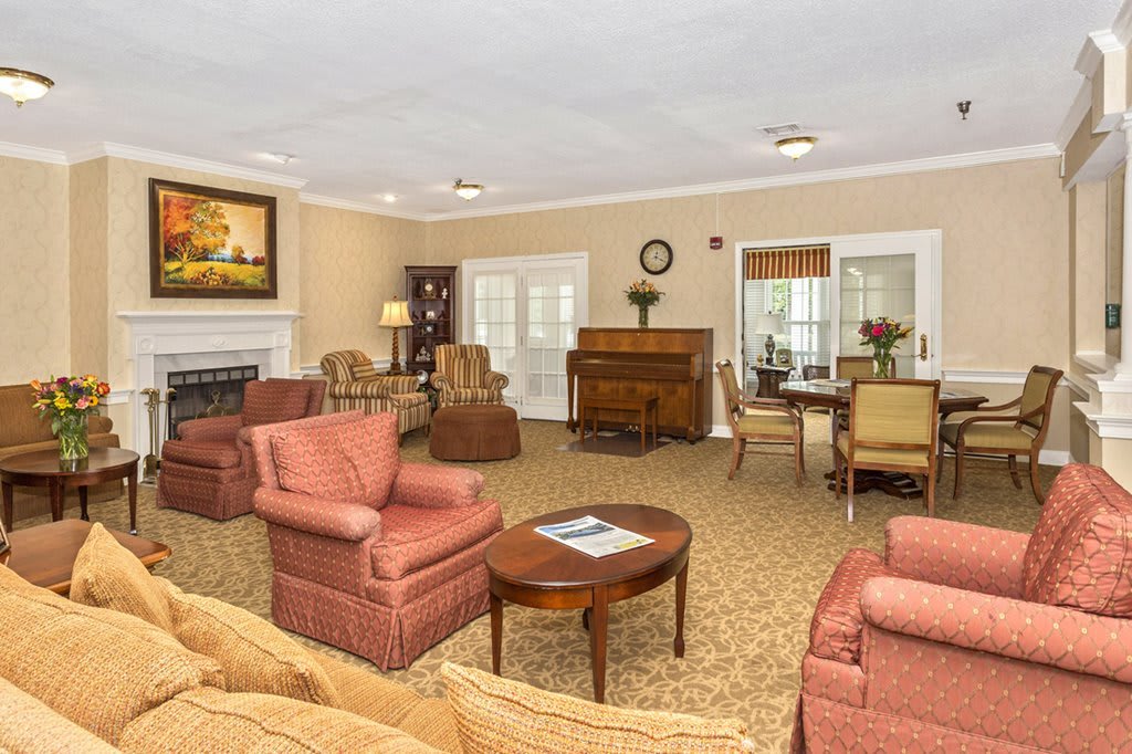 A cozy living room with comfortable armchairs, a sofa, and a coffee table.