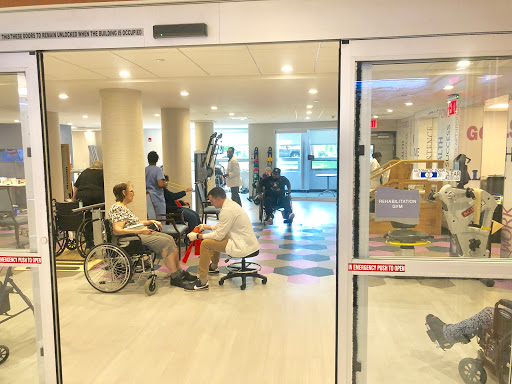 A view of a hospital rehabilitation area with patients receiving care.