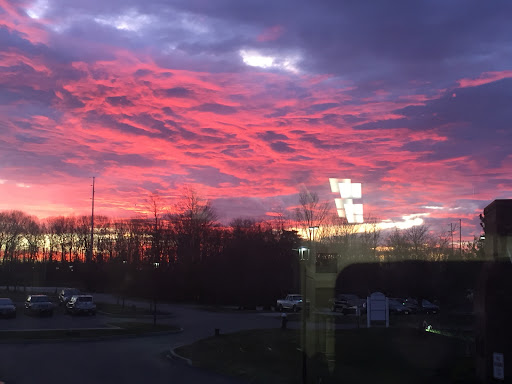A vibrant sunset paints the sky with shades of pink and purple.