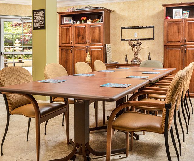 A well-organized conference room with a large meeting table and comfortable chairs.