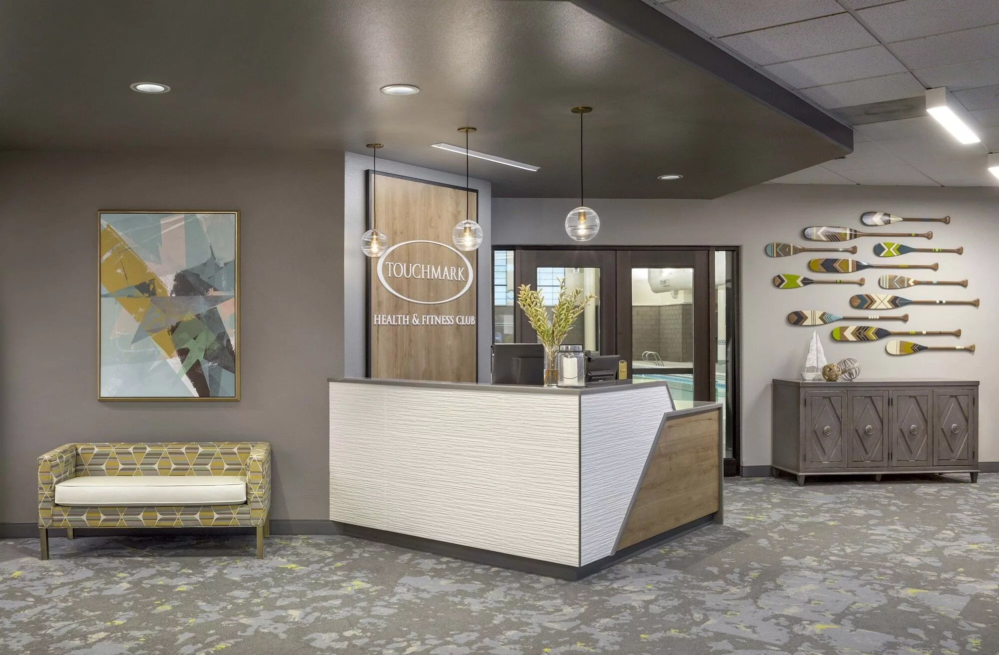 A modern office reception area with stylish furniture and contemporary lighting.