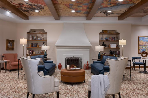 A cozy living room featuring comfortable seating, a fireplace, and elegant decor.