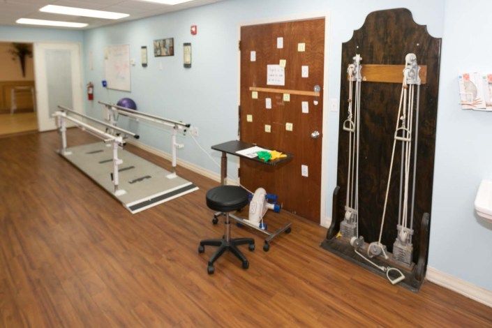 A room in a physical therapy clinic equipped with exercise and rehabilitation tools.