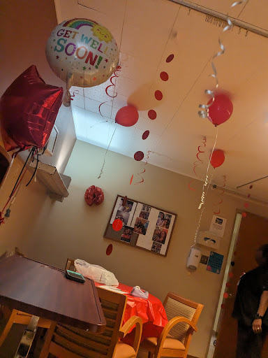 A cozy celebration space adorned with colorful balloons and decorations.