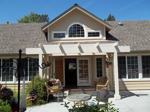 A charming house with a welcoming front porch and well-maintained landscaping.