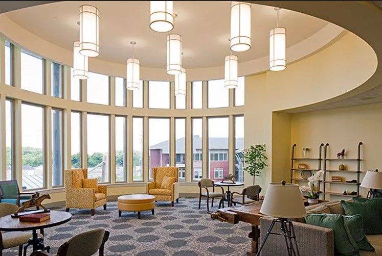 A modern lobby with comfortable seating and large windows allowing natural light to fill the space.