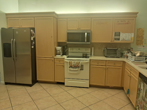 A modern kitchen showcasing essential appliances and cabinetry.