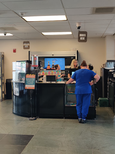 A healthcare reception area where medical staff assist patients.