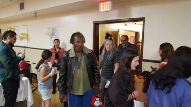 A group of people gathering indoors at an event.