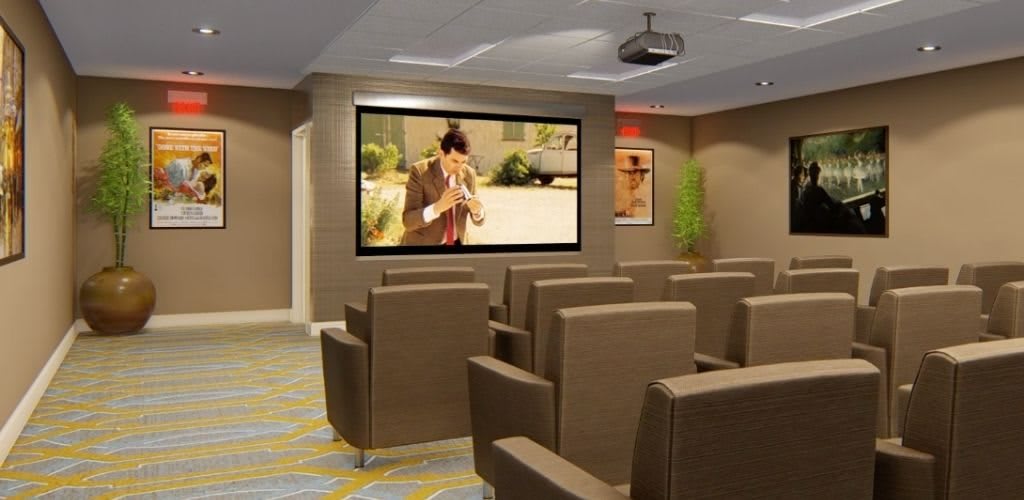 A cozy home theater setup with plush seating and a large projector screen.