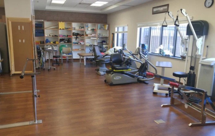 A rehabilitation center with exercise equipment and therapy areas.