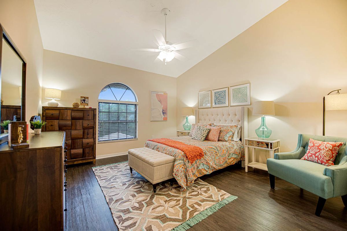 A beautifully decorated bedroom with a comfortable bed, stylish furniture, and elegant lighting.