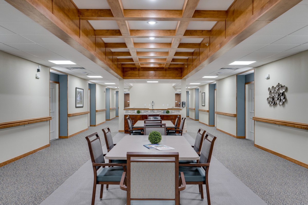 A modern conference room with a long table, chairs, and stylish interior design.