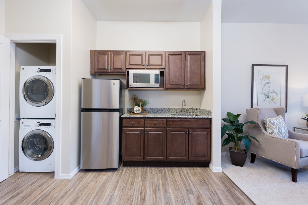 Compact kitchen area with wooden cabinets and modern appliances.