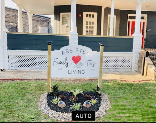 A welcoming sign promoting family living in a beautifully landscaped setting.