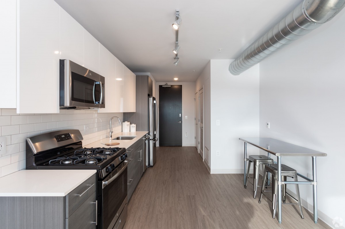 Modern kitchen with stainless steel appliances and minimalist design.