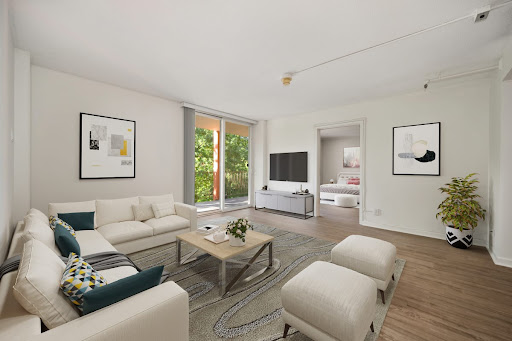 A modern and minimalist living room featuring natural light and stylish furniture.