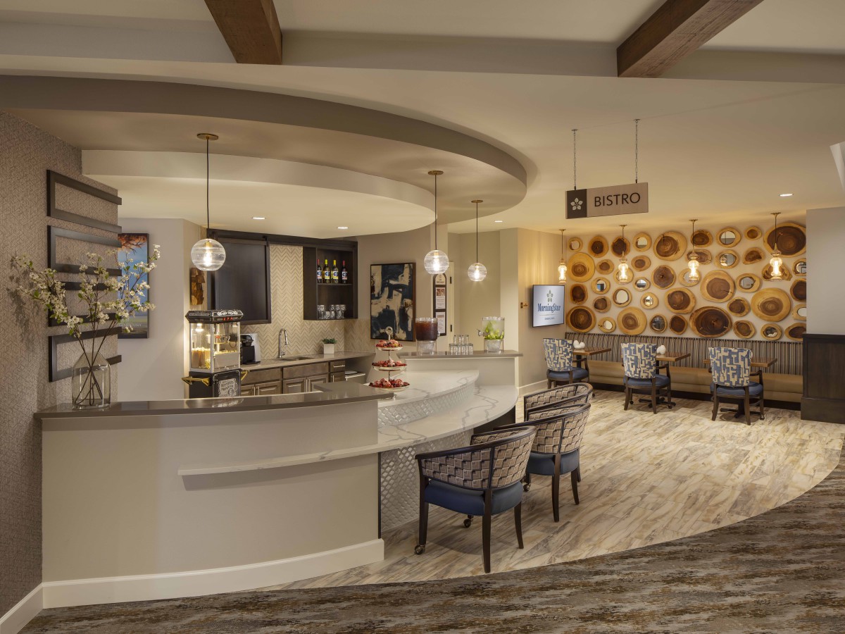 A modern lounge area with a bar and stylish seating.