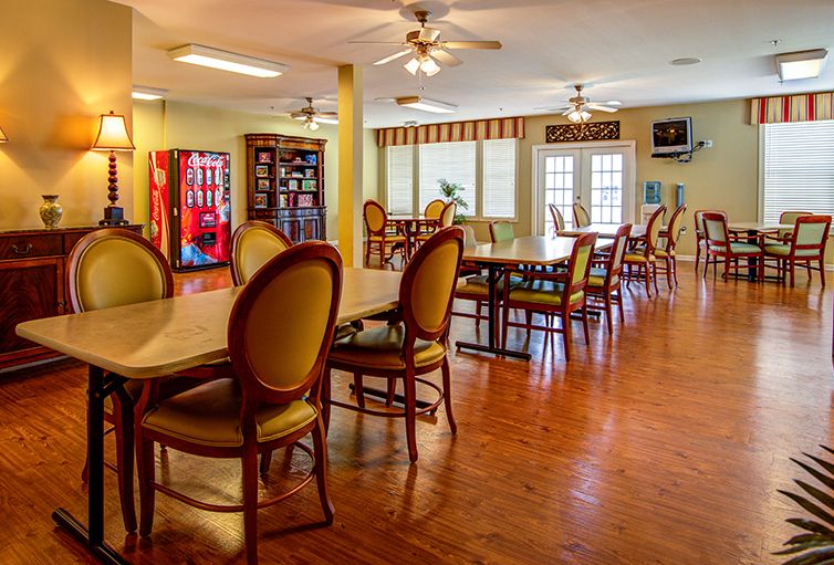An inviting dining area with tables, chairs, and a vending machine.