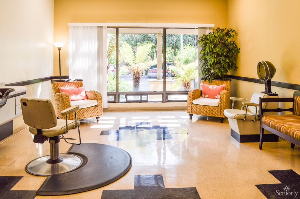 A modern waiting area with comfortable seating and large windows allowing natural light.