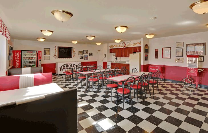 A retro 1950s-style diner with a checkered floor and red and white decor.
