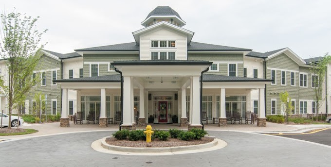 A grand building entrance with prominent columns and landscaped surroundings.