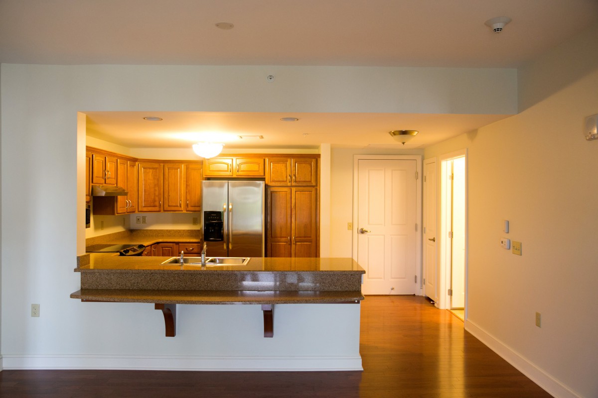 Modern kitchen with wooden cabinets and stainless steel appliances.