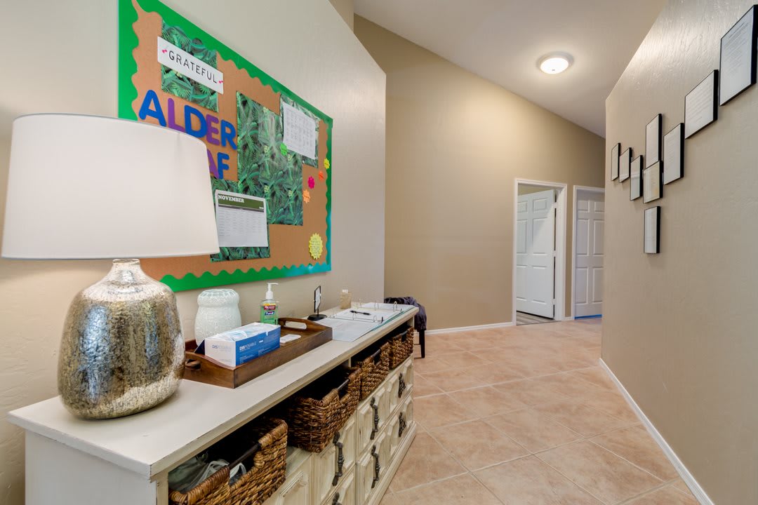 A well-organized hallway with a bulletin board and storage baskets.