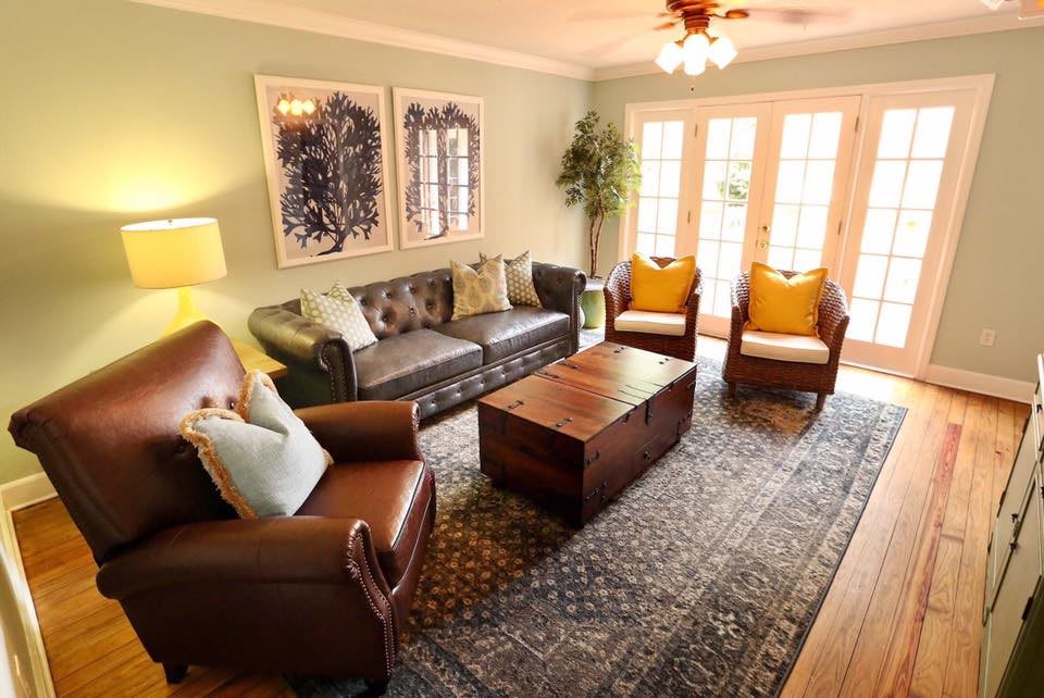 A cozy living room with comfortable seating, a central coffee table, and elegant decor.