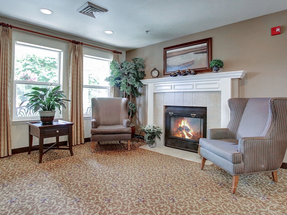 A cozy living room with a fireplace and comfortable seating.