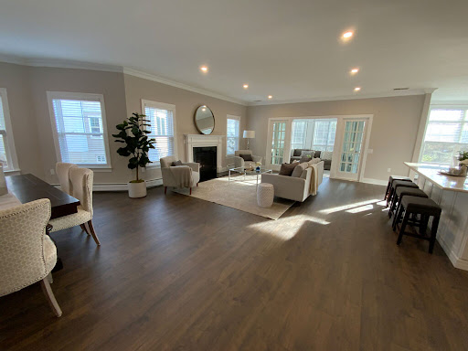 A beautifully designed modern living room filled with natural light and stylish furniture.