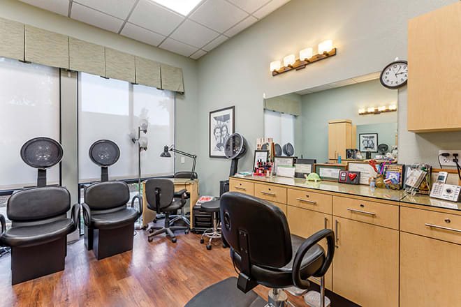 A well-equipped hair salon with chairs, mirrors, and workstations.