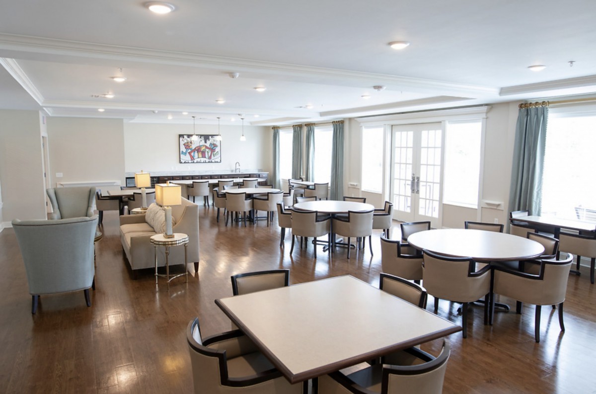A spacious, modern conference room with tables and chairs arranged for meetings.