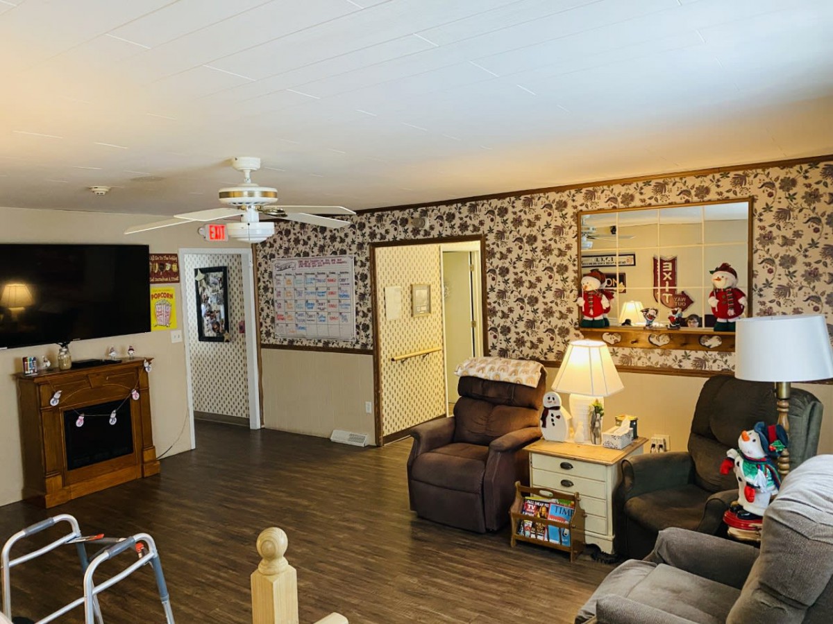 A cozy living room with comfortable seating, a television, and warm lighting.