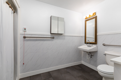 A modern bathroom featuring a stylish sink, a large mirror, and elegant lighting.