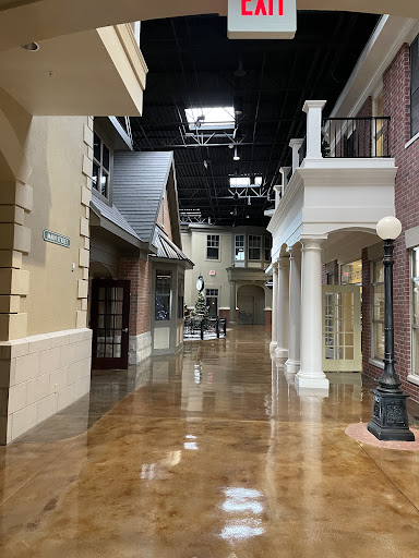 A view of an indoor shopping area featuring a blend of modern and classic architectural styles.
