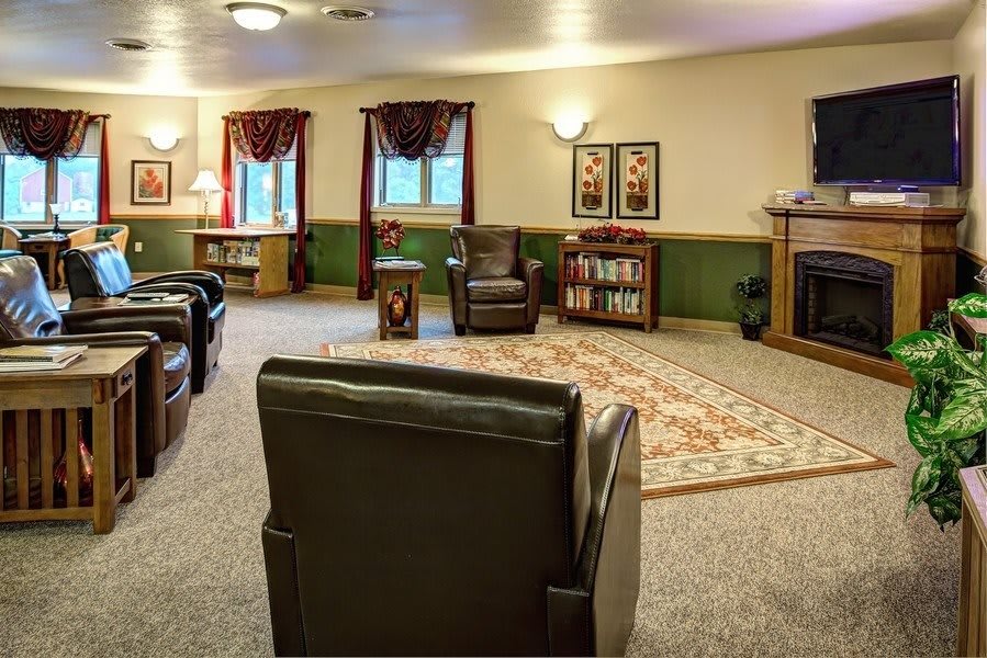 A cozy living room with comfortable seating, a television, and homey decor.