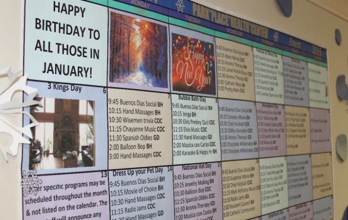 A colorful community board display featuring January birthday announcements and holiday events.