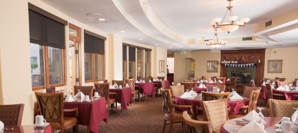 An elegant restaurant dining area with neatly arranged tables and chairs.