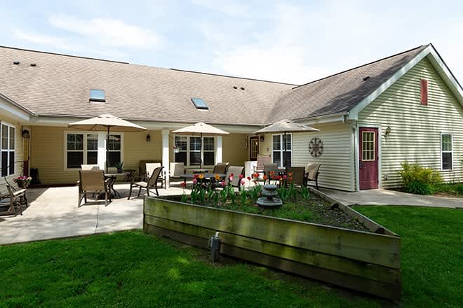 A cozy residential home with a spacious patio and well-maintained lawn.
